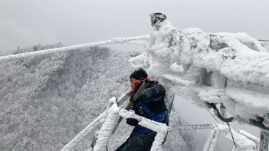 图为武当山索道检修员正在百米高空除冰（朱江 摄）