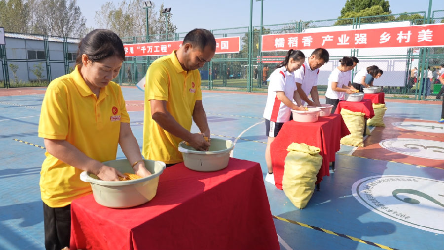 图为农民趣味运动会现场剥玉米（董雪 摄）