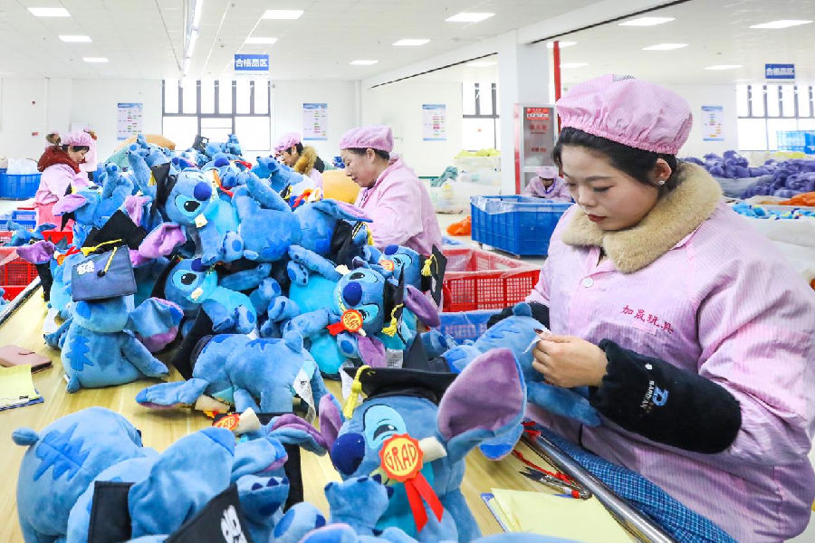 工人们正在给卡通玩具缝制标签（张南宁 摄）
