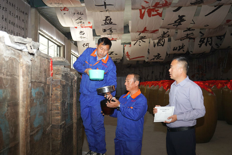 镇赉县镇赉香酒业有限公司负责人高彦宝备泥封“镇赉香”，赠百坛陈酿予高校学子。（王凯 摄）