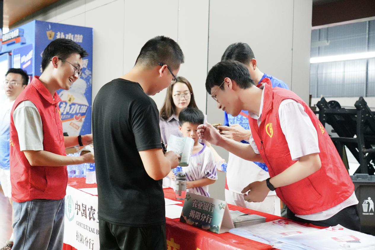 农行揭阳分行青年志愿者现场为参赛选手及观赛群众普及金融知识 （陈超恩 摄）
