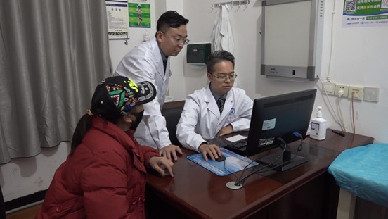 彭伟(右一)与人民医院医师一同研判病人情况(唐险峰 摄)