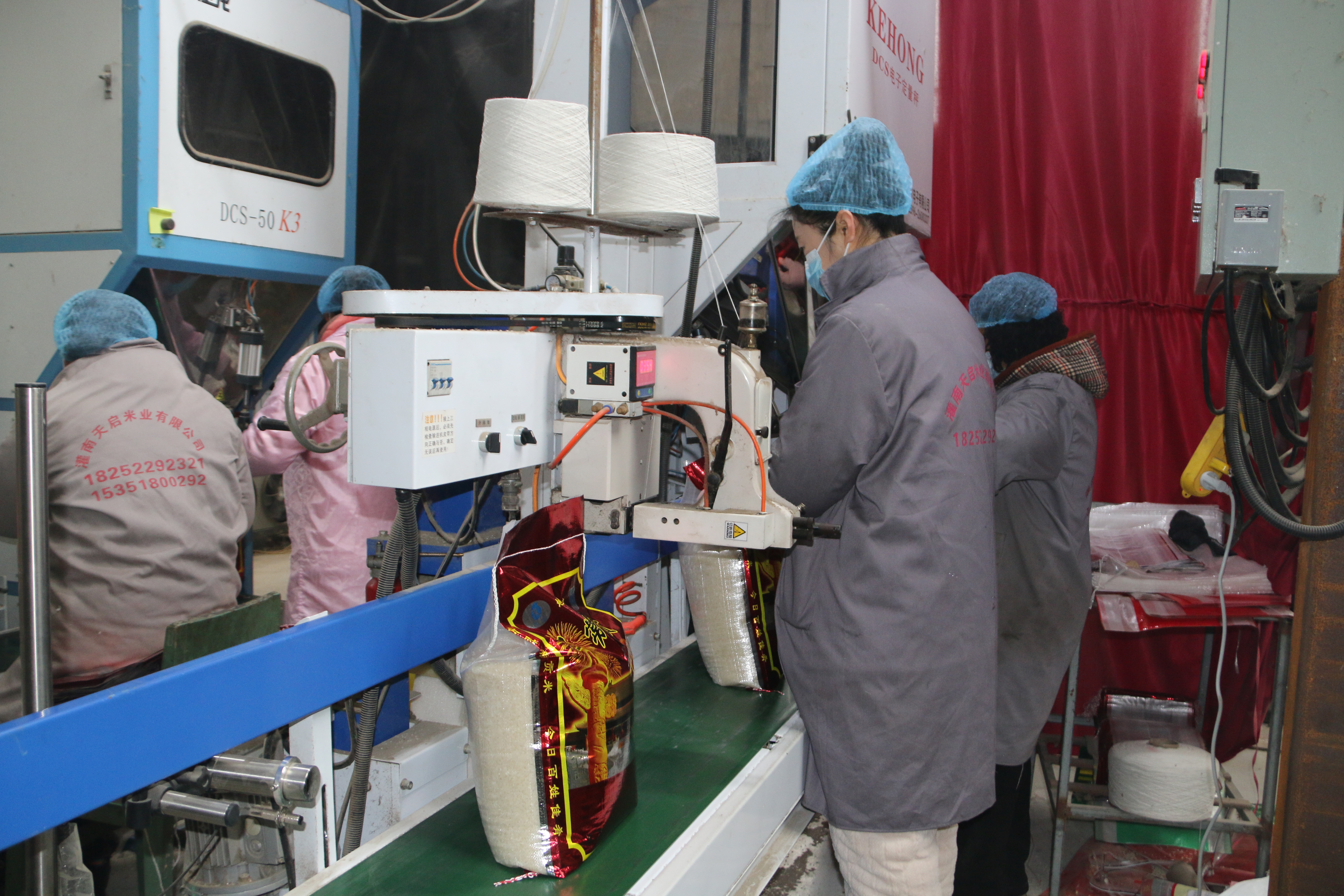灌南天启米业有限公司车间,工人们借助现代化设备提升产能快运行。(方明校 摄)