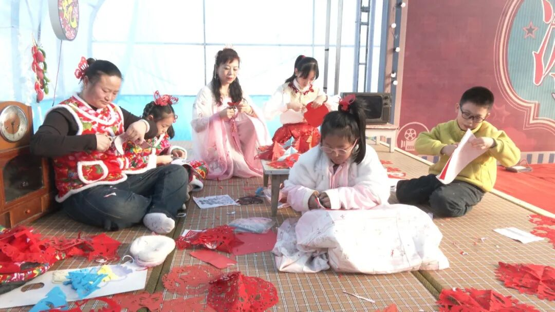 “东北大炕”上现场创作剪纸(邹欣 摄)