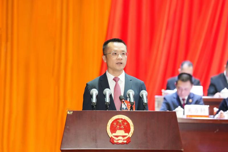 蔡曜泽代表县政府向大会作报告(文宏武 摄)