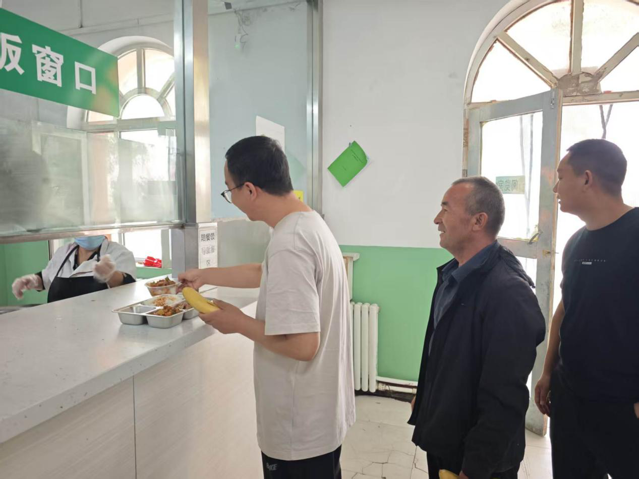 学校老师在排队打饭 (王文光 摄)