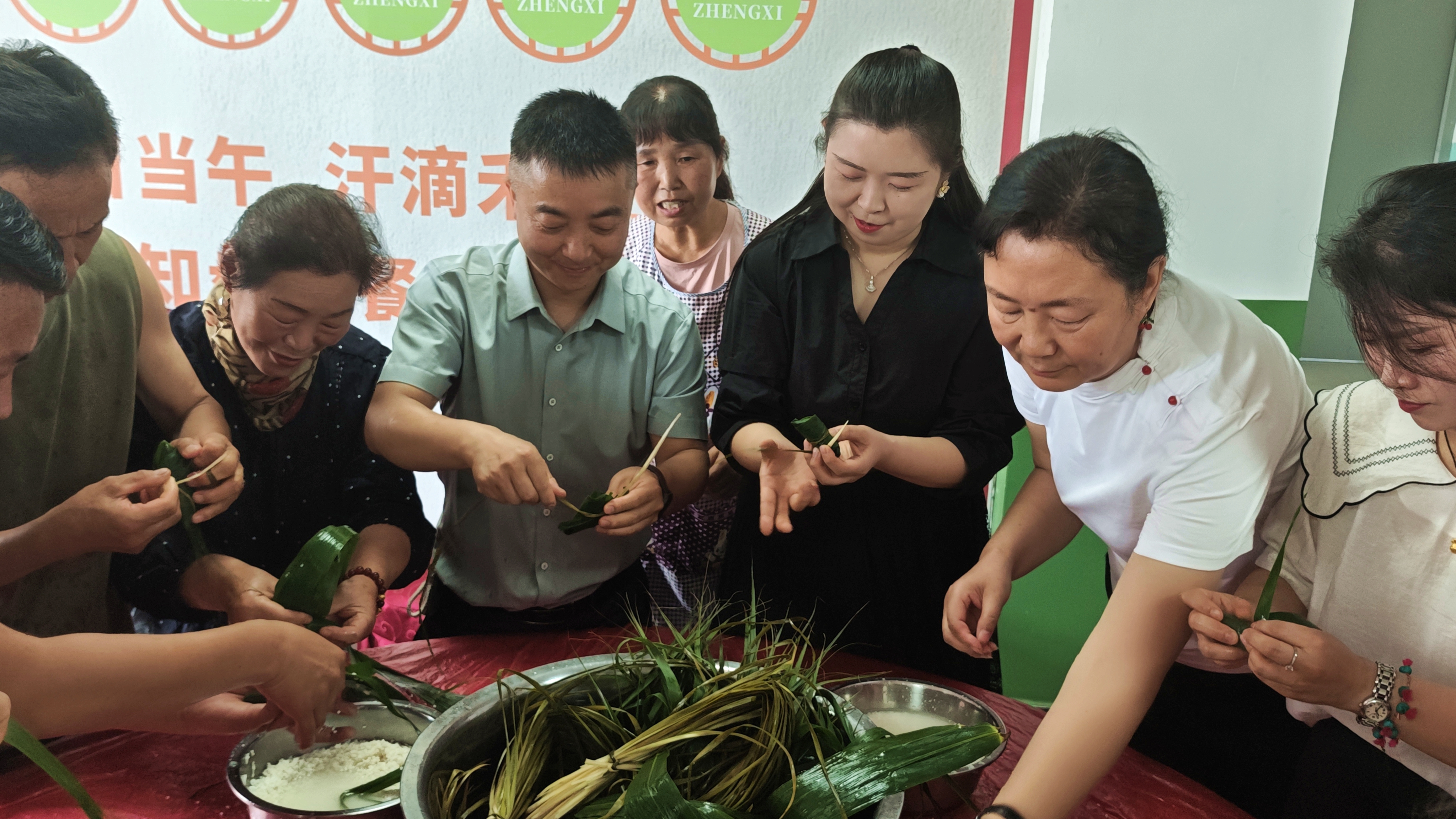 志愿者现场为老人包粽子(张悦 摄)