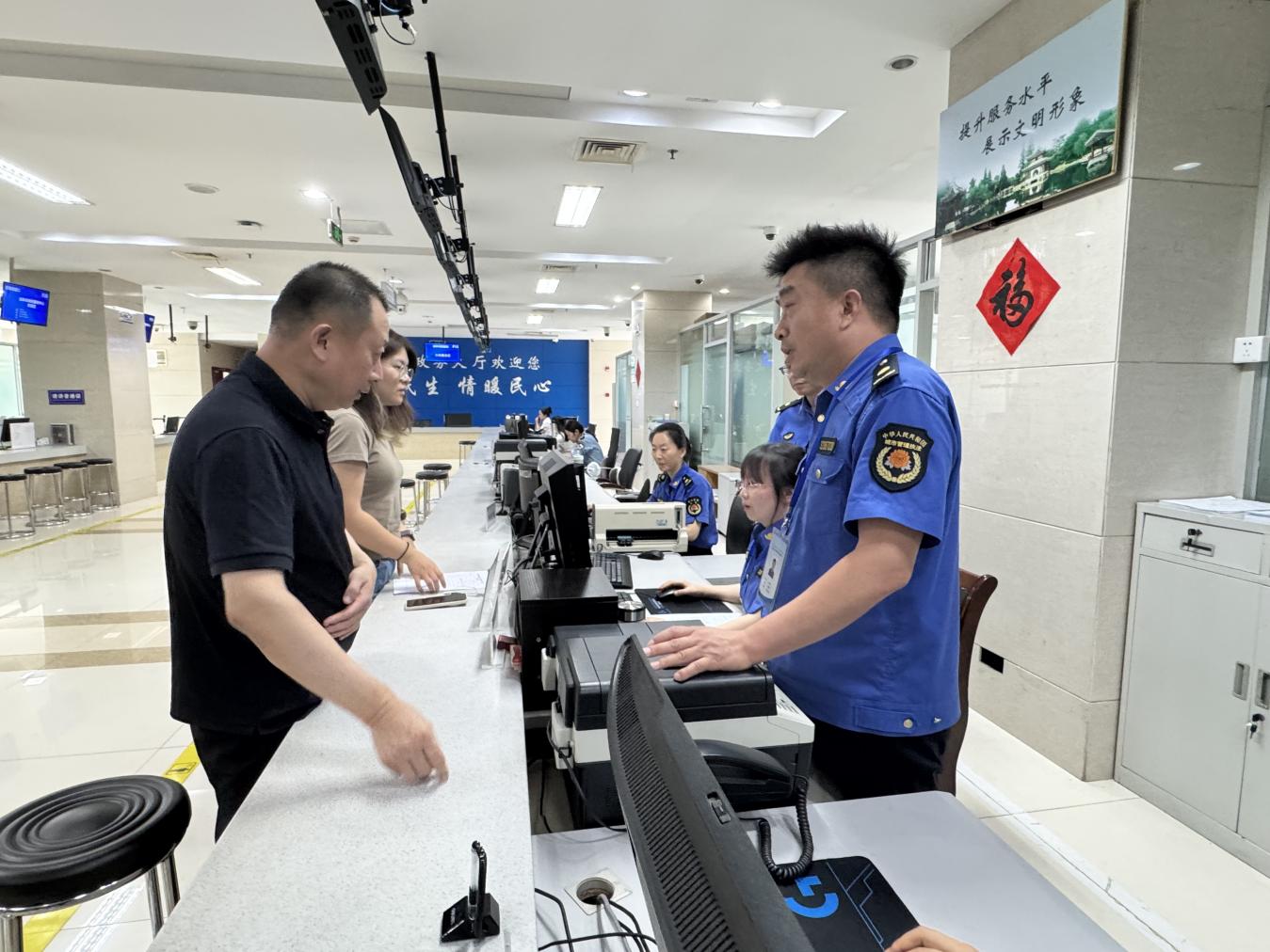 如皋市城管局党组书记、局长卢小冬(右一)体验店招标牌备案 (孙贇 摄)