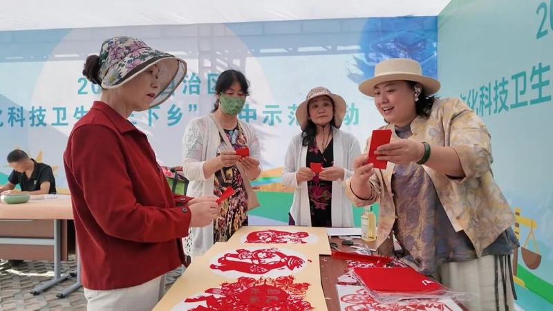 村民们体验非遗剪纸(王旭 摄)