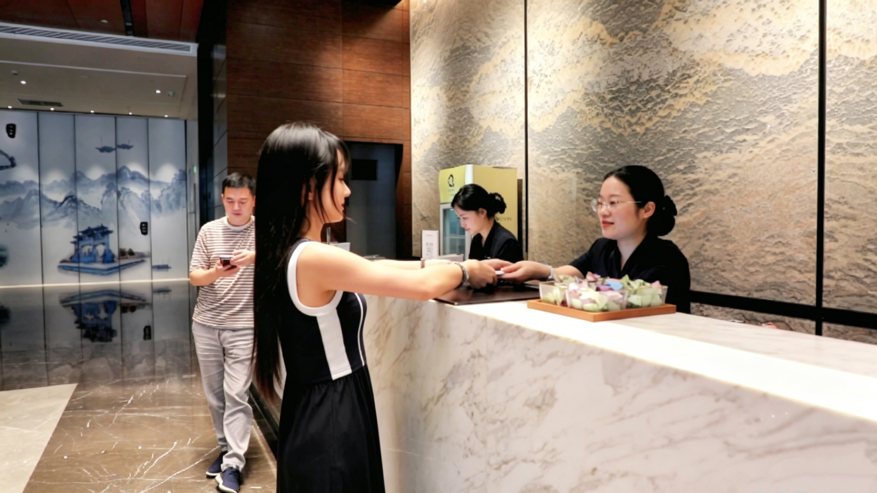 绿地铂骊酒店大堂内,顾客在办理入住。(汪凌蔚 摄)