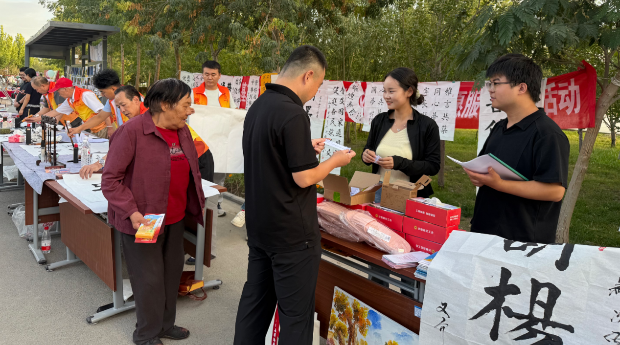 工作人员向过往群众发放国家通用语言文字宣传资料(祖丽皮耶·艾麦尔 摄)