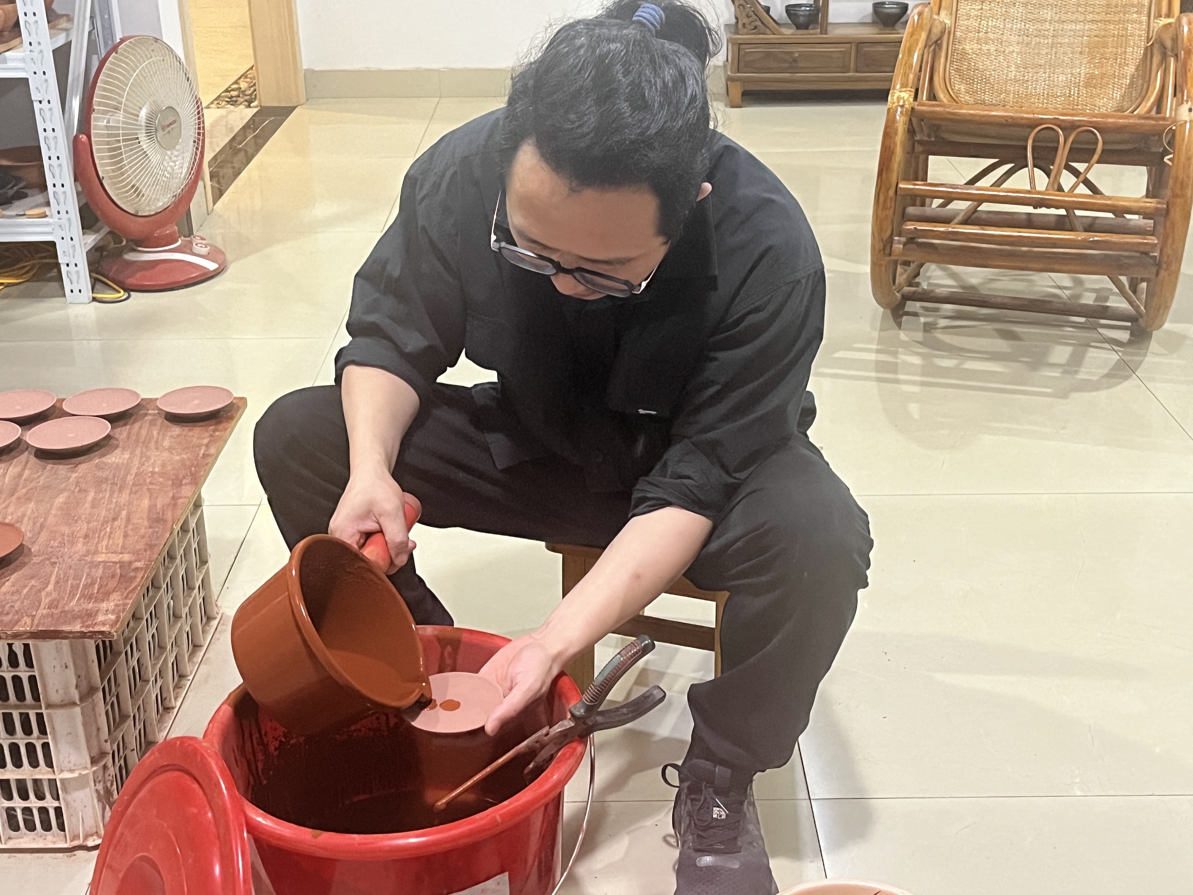 蔡龙的工作间内，工作人员在上釉。（陈似虹 摄）